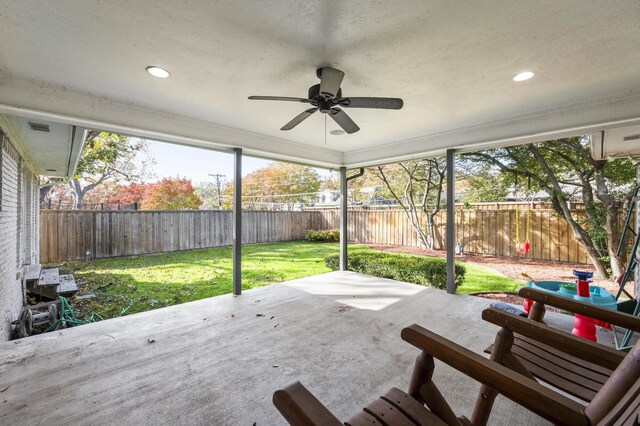 unfurnished sunroom with ceiling fan and plenty of natural light