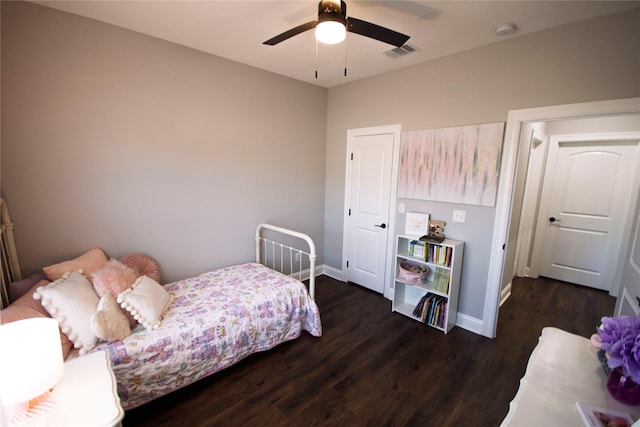 bedroom featuring ceiling fan and dark wood-type flooring