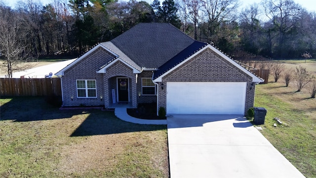 view of front of house featuring a garage and a front lawn