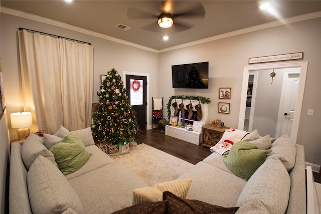 living room with dark hardwood / wood-style floors, ceiling fan, and crown molding