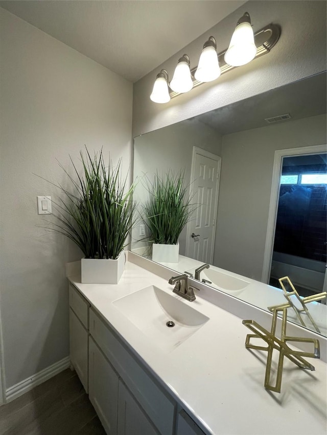 bathroom with vanity and hardwood / wood-style floors