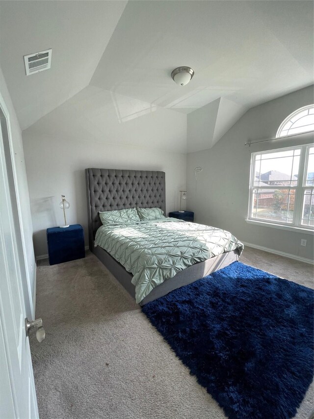 carpeted bedroom featuring vaulted ceiling