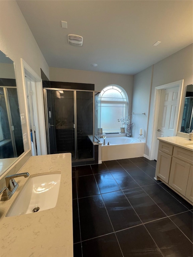 bathroom with vanity, tile patterned flooring, and plus walk in shower