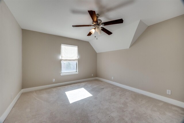 bonus room with ceiling fan, light carpet, and vaulted ceiling