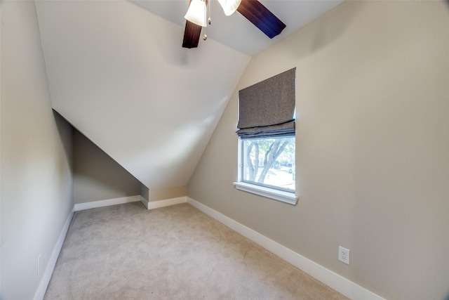 additional living space with light carpet, vaulted ceiling, and ceiling fan