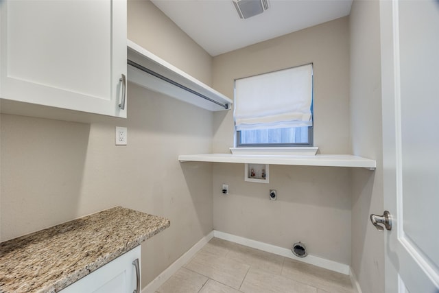 washroom with electric dryer hookup, light tile patterned flooring, cabinets, and hookup for a washing machine