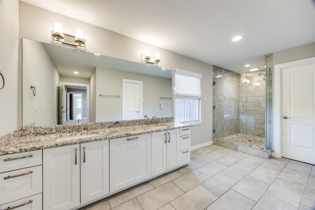 bathroom featuring vanity and a shower with shower door