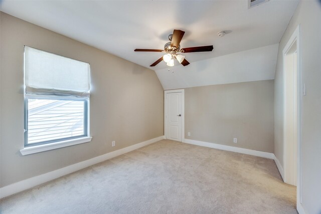 bonus room with ceiling fan, light colored carpet, and vaulted ceiling