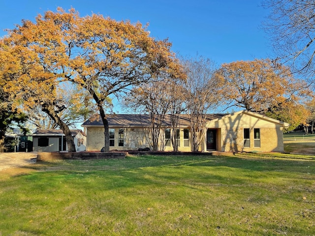 ranch-style house with a front lawn