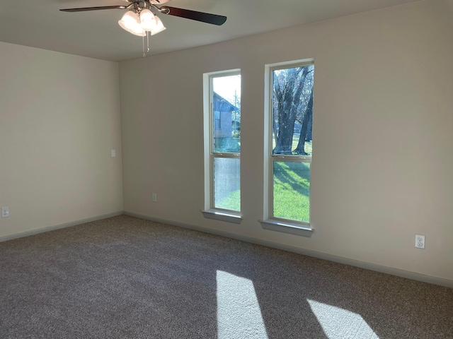 spare room with ceiling fan and carpet