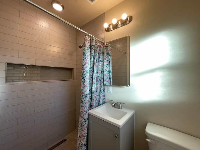 bathroom with vanity, toilet, and a shower with shower curtain