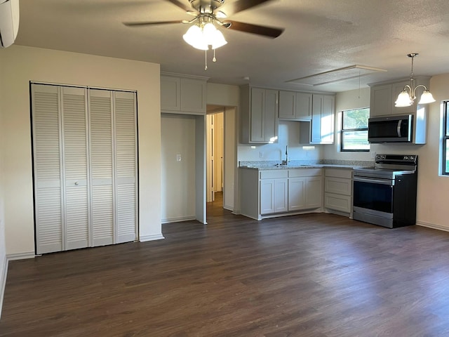 kitchen with sink, decorative light fixtures, appliances with stainless steel finishes, dark hardwood / wood-style floors, and white cabinets