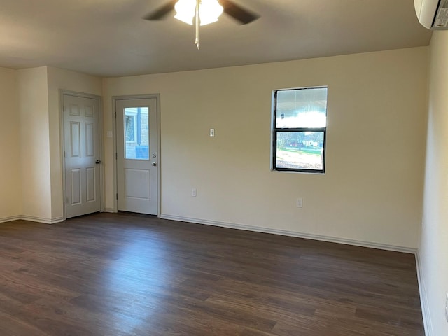 unfurnished room with ceiling fan, dark hardwood / wood-style floors, and a wall mounted AC