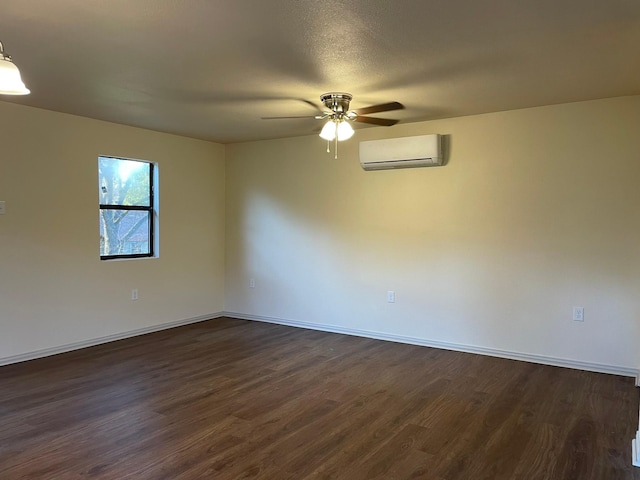 spare room with dark hardwood / wood-style floors, a wall mounted air conditioner, and ceiling fan