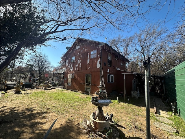 view of side of home featuring a yard