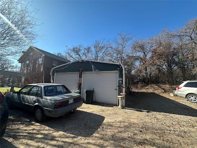 view of side of property featuring a garage and an outbuilding