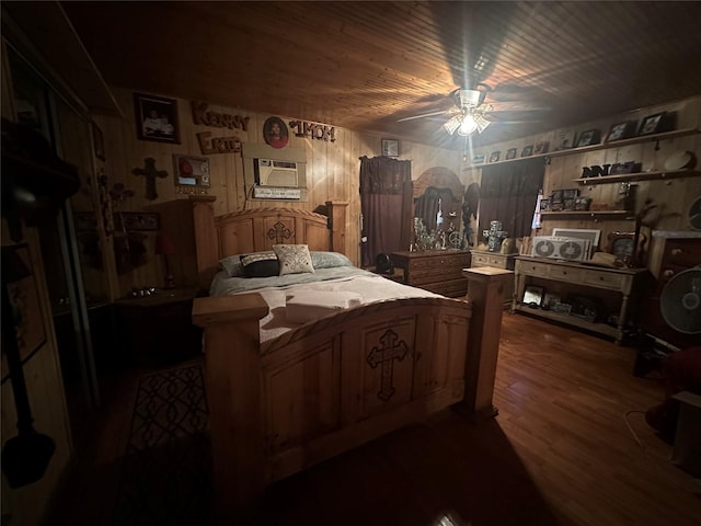 bedroom featuring wood walls, ceiling fan, dark hardwood / wood-style floors, and a wall mounted AC