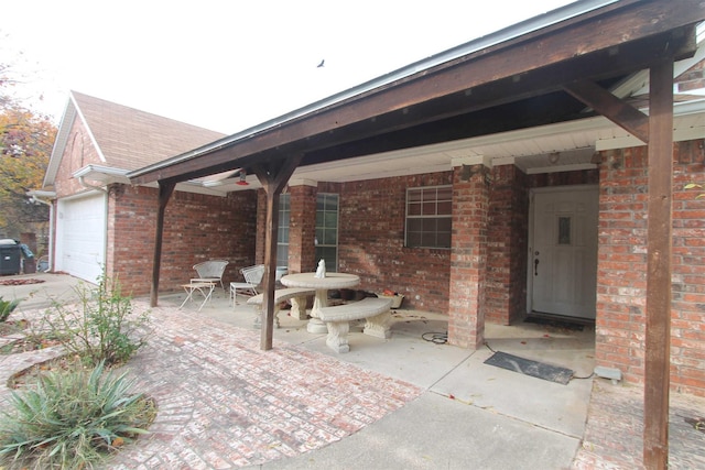 view of patio / terrace with covered porch and a garage