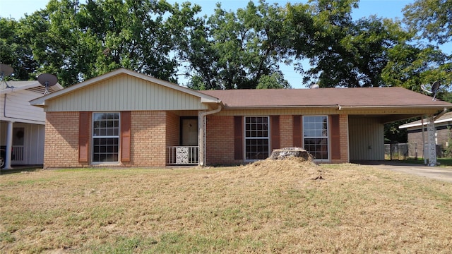 ranch-style house featuring a front yard and a carport