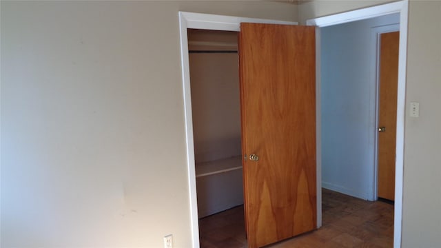 interior space featuring dark hardwood / wood-style flooring and a closet