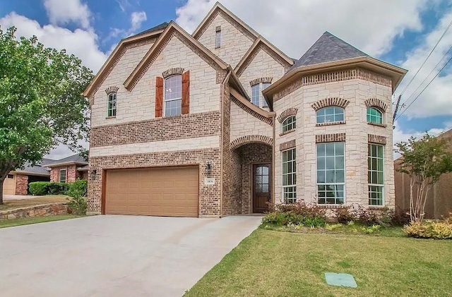 french provincial home featuring a front yard and a garage