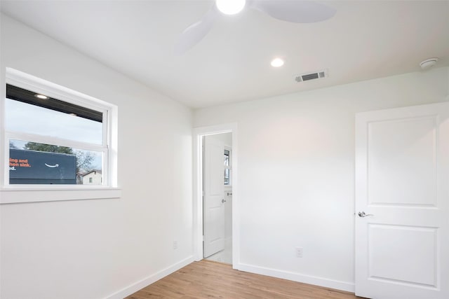 unfurnished room with ceiling fan and light wood-type flooring