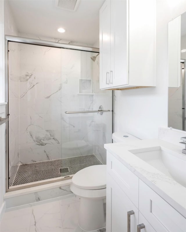 bathroom featuring walk in shower, vanity, and toilet