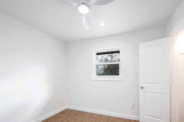 empty room with ceiling fan and light hardwood / wood-style flooring