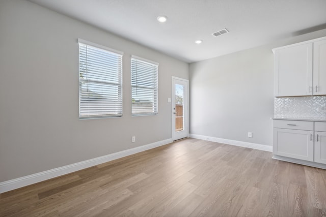 unfurnished dining area featuring light hardwood / wood-style flooring