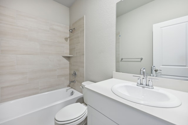 full bathroom featuring toilet, vanity, and tiled shower / bath