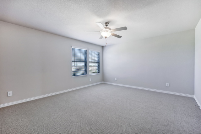 empty room featuring ceiling fan, carpet floors, and a textured ceiling