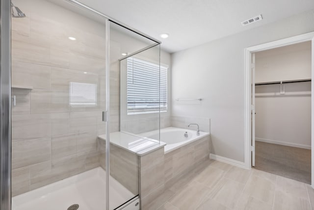 bathroom with tile patterned flooring and independent shower and bath