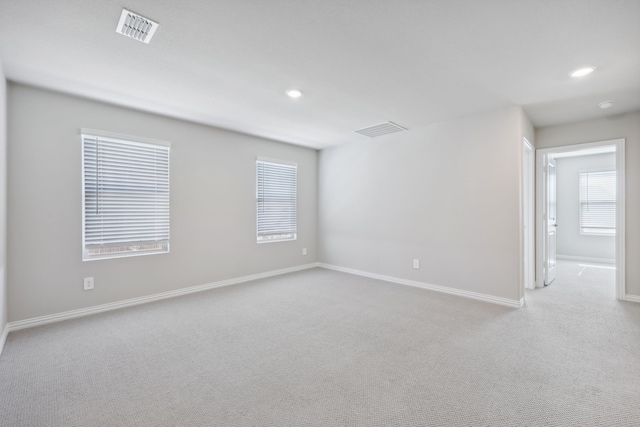 carpeted spare room with a healthy amount of sunlight