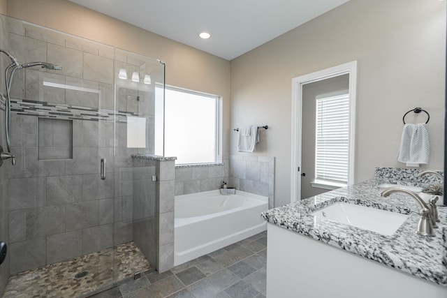 bathroom featuring vanity, a wealth of natural light, and independent shower and bath