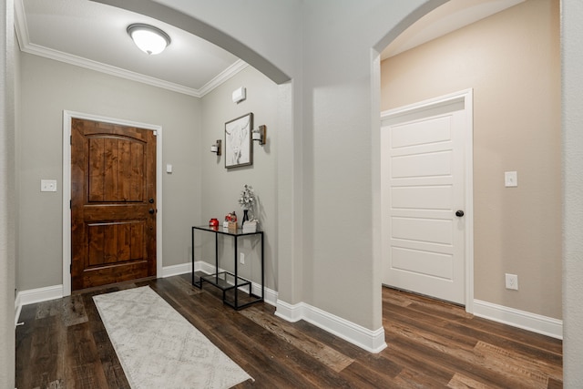 foyer entrance with dark hardwood / wood-style flooring and ornamental molding