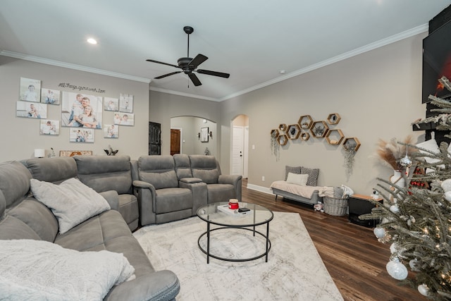 living room featuring dark hardwood / wood-style flooring, ceiling fan, and ornamental molding