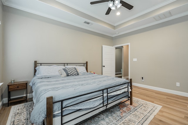 bedroom with hardwood / wood-style flooring, ceiling fan, and ornamental molding