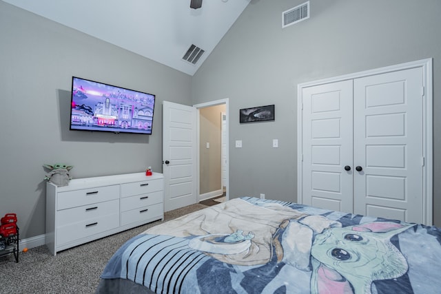 carpeted bedroom with ceiling fan, high vaulted ceiling, and a closet