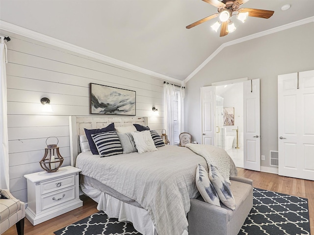 bedroom with ceiling fan, wood-type flooring, lofted ceiling, and ornamental molding