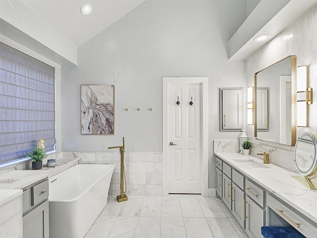 bathroom featuring vanity, tile walls, and a tub