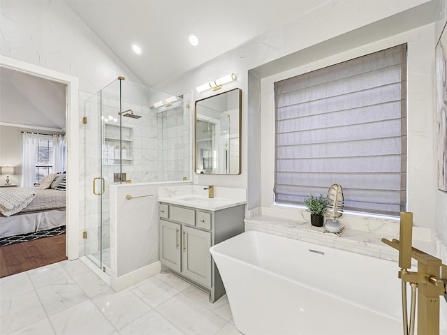 bathroom with vanity, lofted ceiling, and independent shower and bath