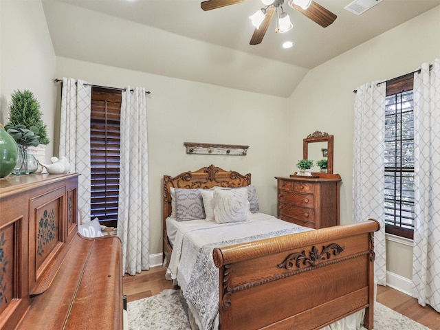 bedroom with hardwood / wood-style floors, ceiling fan, and lofted ceiling