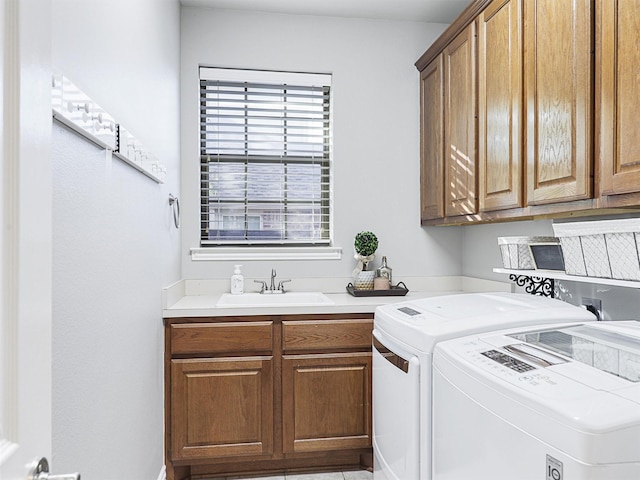 laundry room with cabinets, independent washer and dryer, and sink