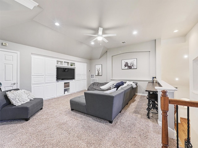 carpeted living room with built in shelves, ceiling fan, and lofted ceiling