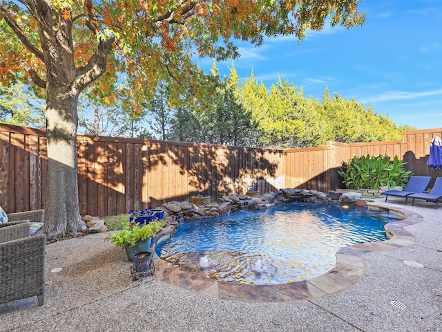 view of pool featuring pool water feature and a patio