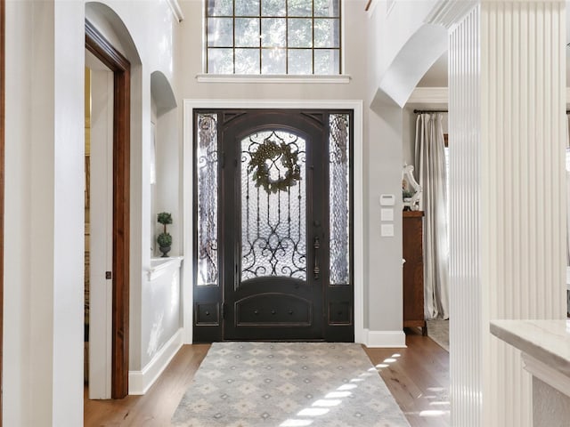 entrance foyer featuring a high ceiling and light wood-type flooring