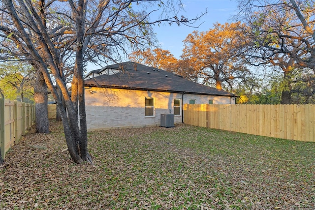 back of house featuring a yard and cooling unit