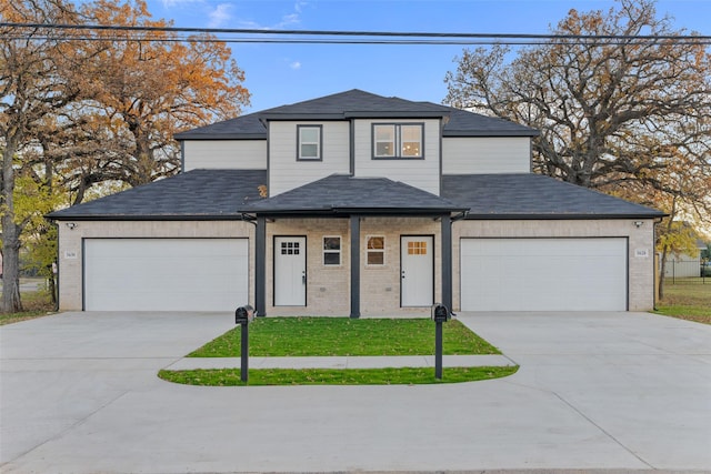 view of front of home featuring a front yard and a garage