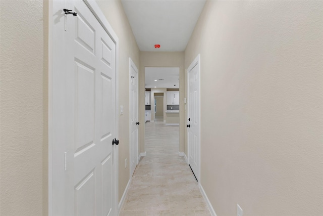 corridor featuring light tile patterned flooring