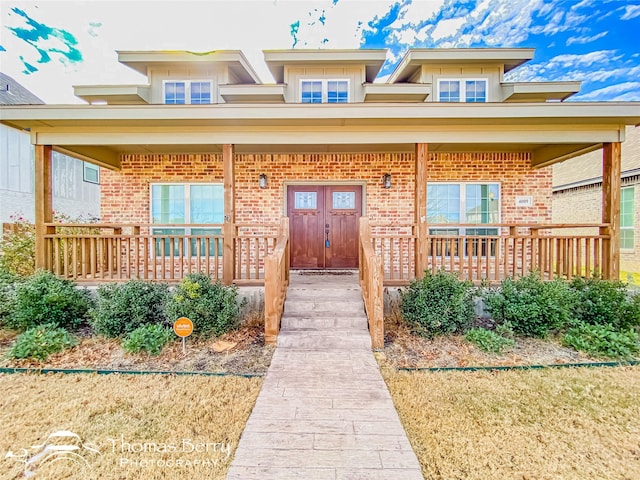 view of front of house with a front yard and a porch